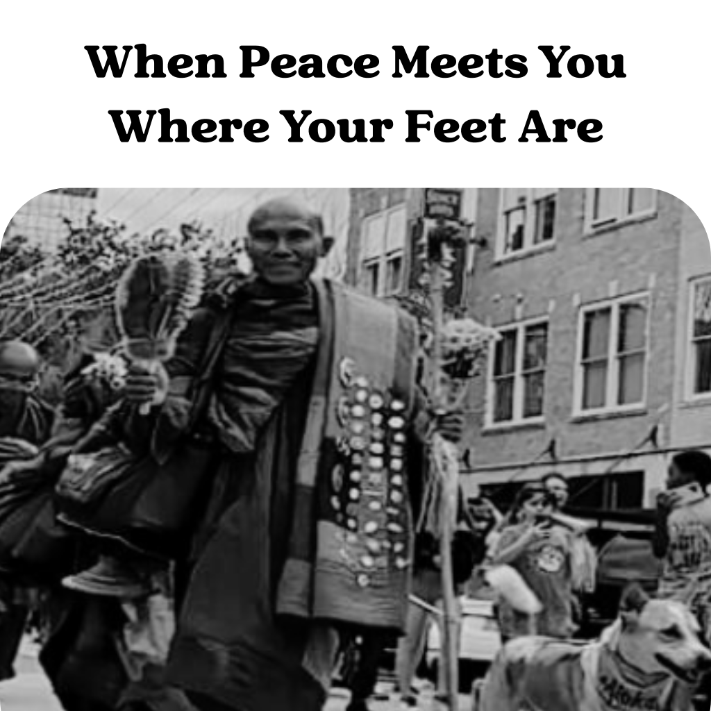 Black-and-white photo of monks walking in a city; text reads, When Peace Meets You Where Your Feet Are.