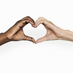 Two hands, one dark-skinned and one light-skinned, forming a heart shape against a white background.
